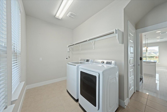 9305 Mcknight Loop Unit 4, Austin, TX 78717 - laundry area featuring separate washer and dryer, baseboards, and light tile patterned flooring