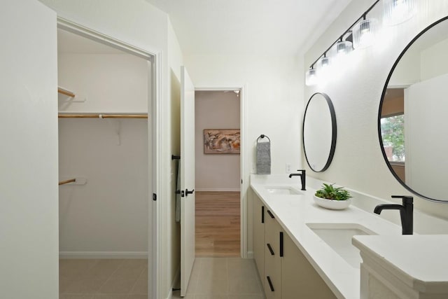 21017 Secretariat Ridge Ln, Pflugerville, TX 78660 - full bath featuring double vanity, tile patterned flooring, a walk in closet, and baseboards