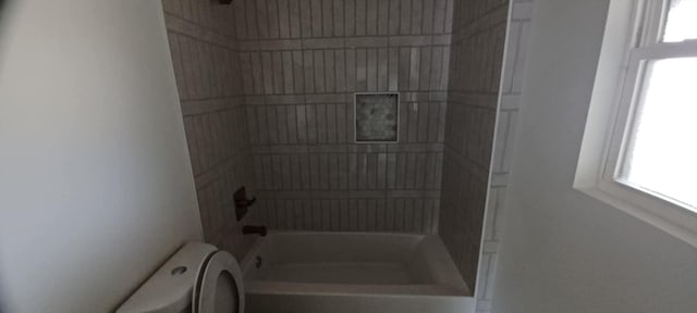 2101 Vanderbilt Ln, Austin, TX 78723 - bathroom with toilet, healthy amount of natural light, and bathing tub / shower combination