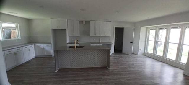 2101 Vanderbilt Ln, Austin, TX 78723 - kitchen featuring a sink, healthy amount of natural light, an island with sink, and white cabinets