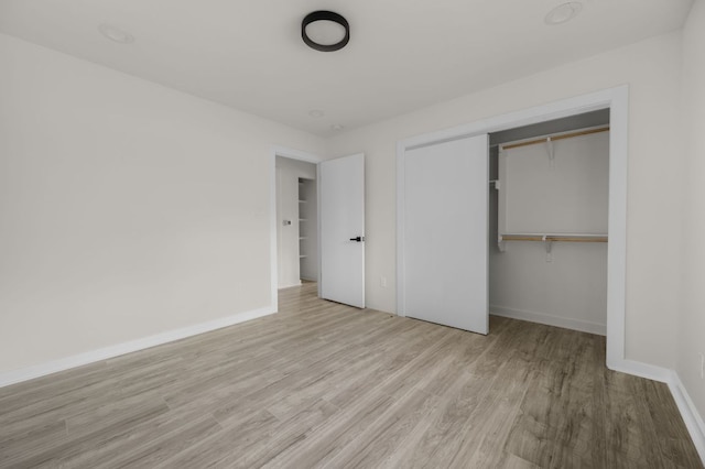 2101 Vanderbilt Ln, Austin, TX 78723 - unfurnished bedroom featuring wood finished floors and a closet