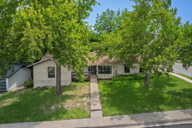 2101 Vanderbilt Ln, Austin, TX 78723 - obstructed view of property featuring brick siding and a front yard