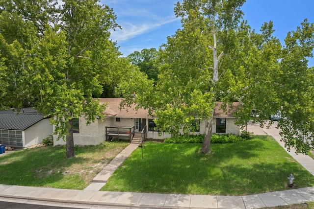 2101 Vanderbilt Ln, Austin, TX 78723 - view of property hidden behind natural elements featuring a front lawn and covered porch