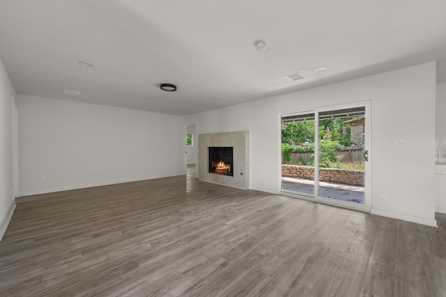2101 Vanderbilt Ln, Austin, TX 78723 - unfurnished living room featuring wood finished floors and a fireplace