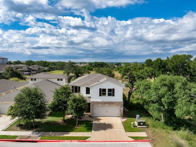 299 Diamond Point Dr, Dripping Springs, TX 78620 - view of front of home with concrete driveway, a garage, and brick siding
