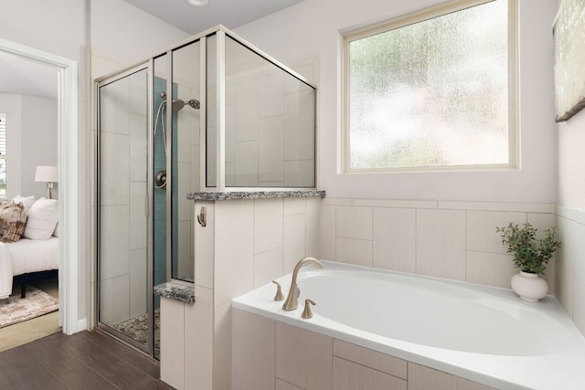 299 Diamond Point Dr, Dripping Springs, TX 78620 - ensuite bathroom featuring plenty of natural light, a stall shower, a garden tub, and wood finished floors