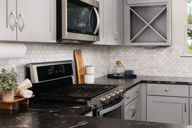 299 Diamond Point Dr, Dripping Springs, TX 78620 - kitchen with stainless steel appliances, backsplash, and dark stone countertops