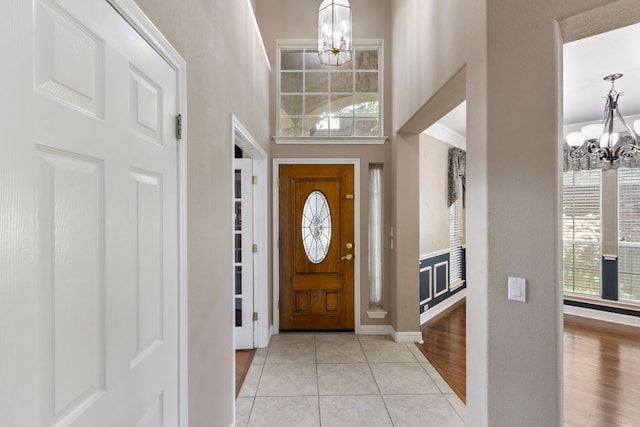 9501 Aire Libre Dr, Austin, TX 78726 - entrance foyer featuring a chandelier, plenty of natural light, a towering ceiling, baseboards, and light tile patterned flooring