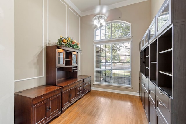 9501 Aire Libre Dr, Austin, TX 78726 - entryway with light wood-type flooring, baseboards, crown molding, and a chandelier