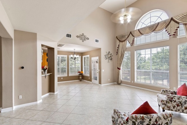 9501 Aire Libre Dr, Austin, TX 78726 - living area with a chandelier, plenty of natural light, light tile patterned flooring, and a towering ceiling