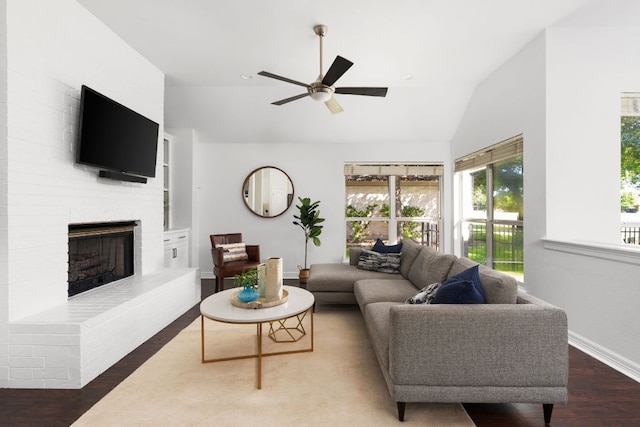 10833 Olympia Fields Loop, Austin, TX 78747 - living area featuring vaulted ceiling, wood finished floors, a ceiling fan, a fireplace, and baseboards