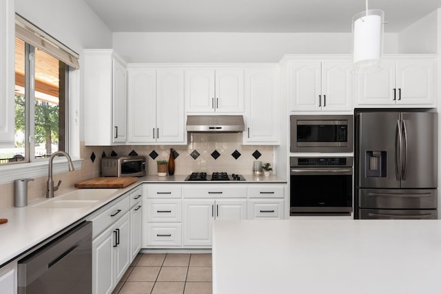 10833 Olympia Fields Loop, Austin, TX 78747 - kitchen featuring stainless steel appliances, a sink, exhaust hood, backsplash, and white cabinetry