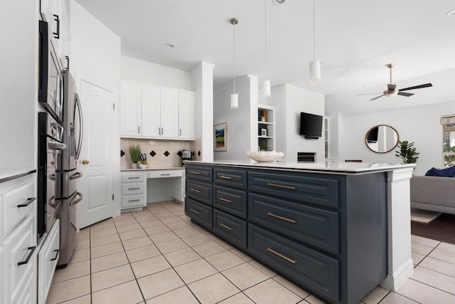 10833 Olympia Fields Loop, Austin, TX 78747 - kitchen featuring open floor plan, white cabinetry, blue cabinetry, light tile patterned floors, and a ceiling fan