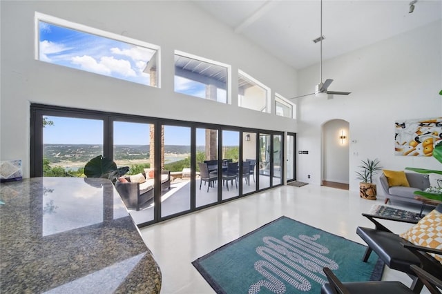 13902 Panorama Dr, Austin, TX 78732 - living room with arched walkways, plenty of natural light, a towering ceiling, and ceiling fan