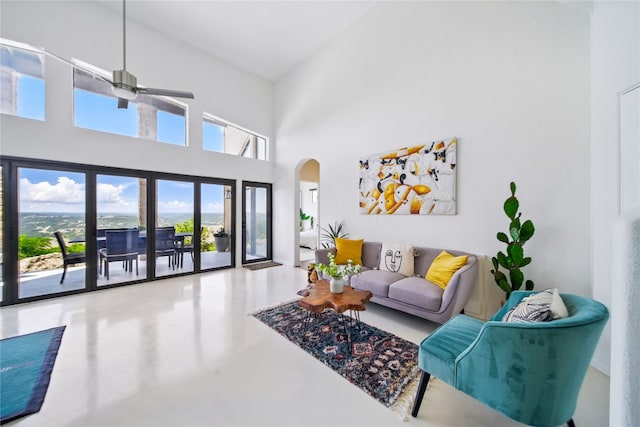 13902 Panorama Dr, Austin, TX 78732 - living room with arched walkways, ceiling fan, a high ceiling, and concrete floors