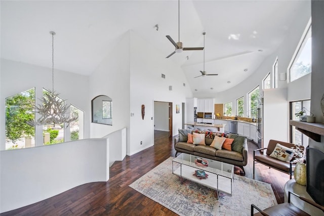 13902 Panorama Dr, Austin, TX 78732 - living room with high vaulted ceiling, a ceiling fan, dark wood-type flooring, and a chandelier
