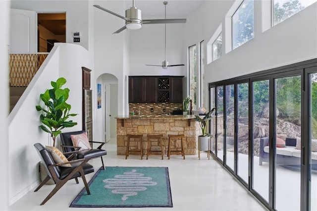 13902 Panorama Dr, Austin, TX 78732 - living area featuring a towering ceiling, a ceiling fan, and arched walkways