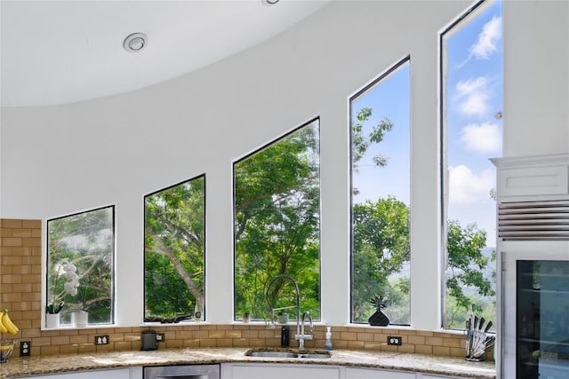 13902 Panorama Dr, Austin, TX 78732 - kitchen view of a sink, tasteful backsplash, light stone counters, and beverage cooler