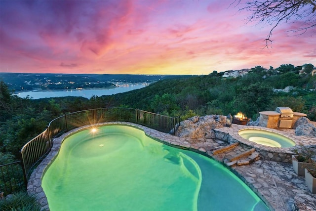 13902 Panorama Dr, Austin, TX 78732 - pool at dusk featuring an in-ground hot tub