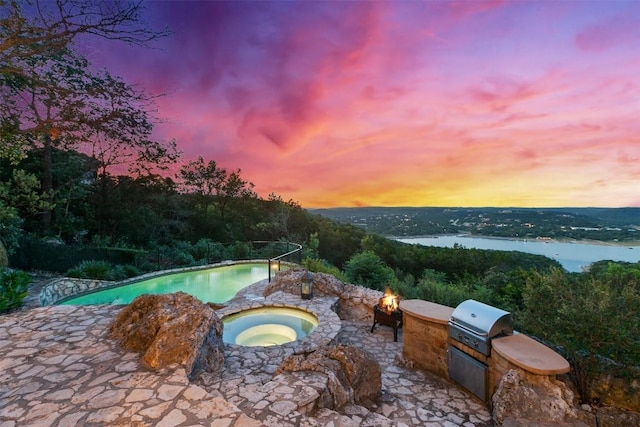 13902 Panorama Dr, Austin, TX 78732 - outdoor pool with a fire pit, an in-ground hot tub, a patio area, and a water view