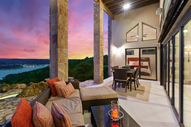 13902 Panorama Dr, Austin, TX 78732 - patio terrace at dusk with outdoor dining area and an outdoor hangout area