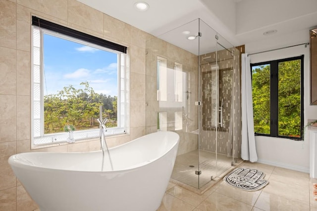 13902 Panorama Dr, Austin, TX 78732 - full bathroom featuring a freestanding tub, tile walls, a stall shower, tile patterned flooring, and recessed lighting