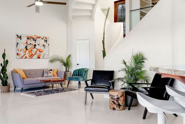13902 Panorama Dr, Austin, TX 78732 - sitting room featuring a ceiling fan, arched walkways, a high ceiling, and concrete floors