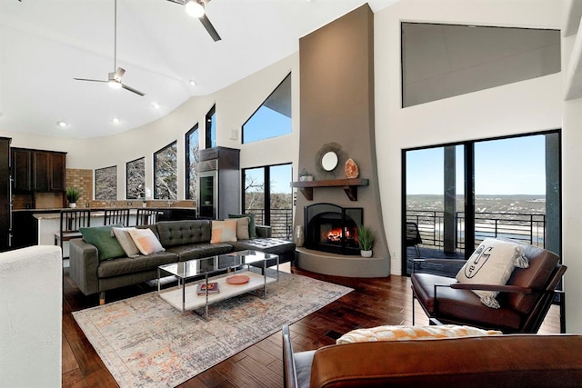 13902 Panorama Dr, Austin, TX 78732 - living area featuring a ceiling fan, high vaulted ceiling, recessed lighting, a large fireplace, and dark wood-type flooring