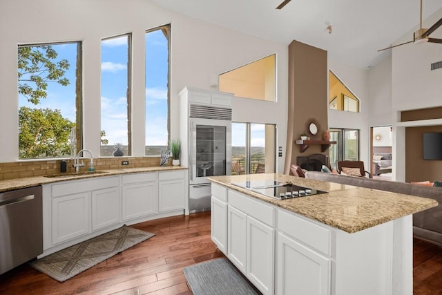 13902 Panorama Dr, Austin, TX 78732 - kitchen featuring stainless steel appliances, open floor plan, wood-type flooring, high vaulted ceiling, and light stone counters