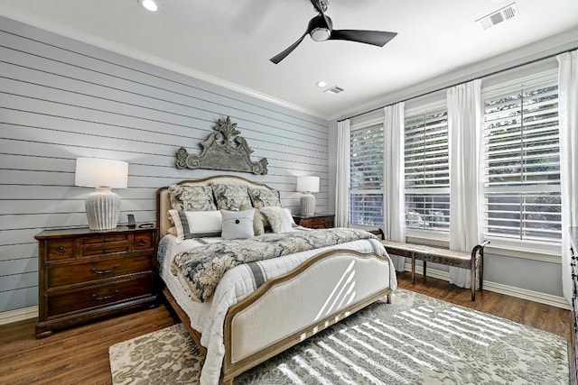 404 Riley Trl, Cedar Park, TX 78613 - bedroom featuring wood finished floors, baseboards, wooden walls, a ceiling fan, and recessed lighting