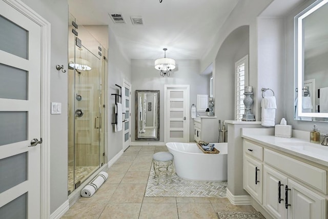 404 Riley Trl, Cedar Park, TX 78613 - bathroom with a shower stall, vanity, a soaking tub, tile patterned flooring, and a chandelier