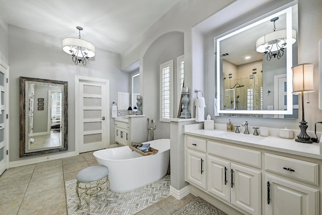 404 Riley Trl, Cedar Park, TX 78613 - bathroom featuring a chandelier, a stall shower, vanity, and a freestanding tub