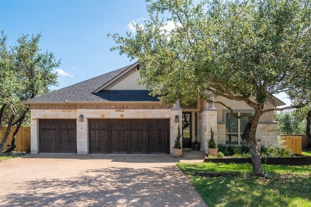 1225 Grassy Field Rd, Austin, TX 78737 - view of front of property featuring stone siding, a garage, driveway, and a shingled roof