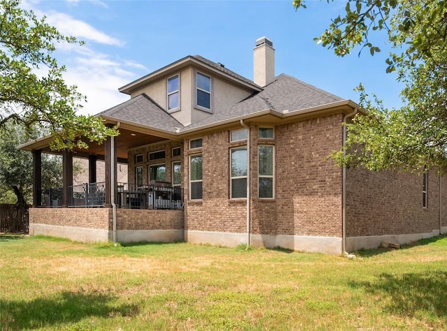 1225 Grassy Field Rd, Austin, TX 78737 - back of house with a lawn, a chimney, brick siding, and a shingled roof