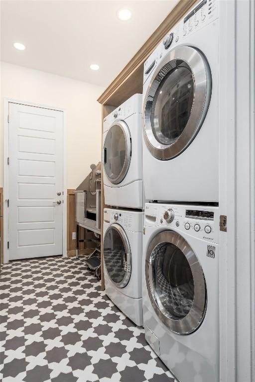 1225 Grassy Field Rd, Austin, TX 78737 - laundry room featuring tile patterned floors, stacked washer / dryer, washer and dryer, and recessed lighting
