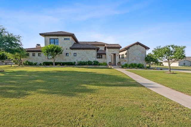 260 Unbridled, Austin, TX 78737 - mediterranean / spanish-style house featuring stone siding, a front yard, a tiled roof, a chimney, and stucco siding