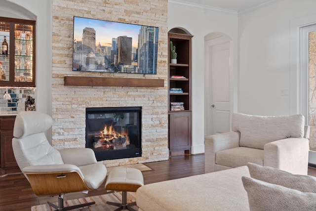 260 Unbridled, Austin, TX 78737 - living area featuring ornamental molding, dark wood-style flooring, a fireplace, arched walkways, and a view of skyline