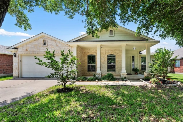 2128 Pearson Way, Round Rock, TX 78665 - view of front facade with a garage, concrete driveway, stone siding, a front lawn, and a porch