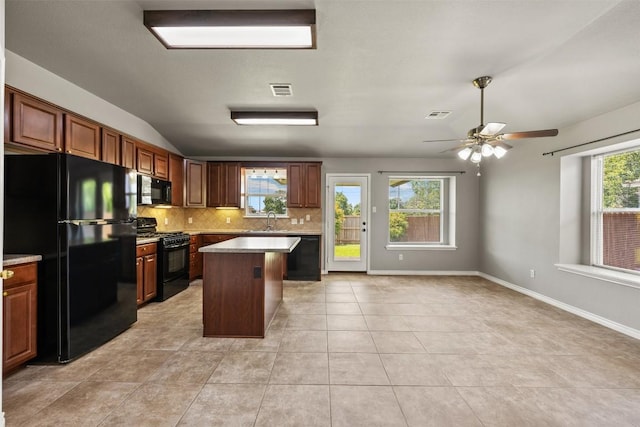 2128 Pearson Way, Round Rock, TX 78665 - kitchen featuring black appliances, tasteful backsplash, a ceiling fan, a kitchen island, and a sink
