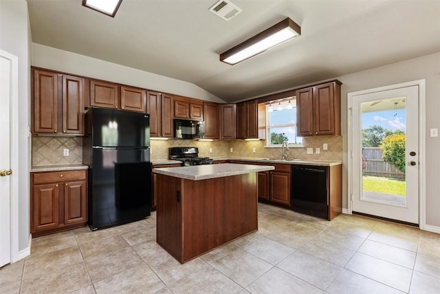 2128 Pearson Way, Round Rock, TX 78665 - kitchen featuring black appliances, lofted ceiling, a sink, a center island, and decorative backsplash