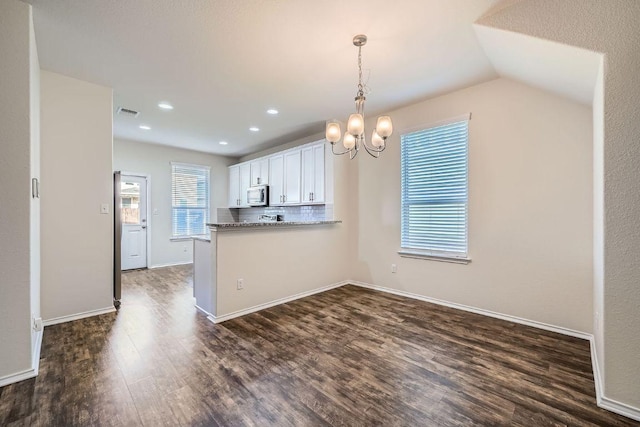 137 Green Egret Way, Leander, TX 78641 - kitchen featuring stainless steel microwave, dark wood-style floors, white cabinetry, a chandelier, and recessed lighting