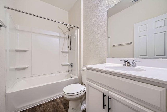 137 Green Egret Way, Leander, TX 78641 - bathroom featuring toilet, wood finished floors, vanity, bathing tub / shower combination, and a textured wall