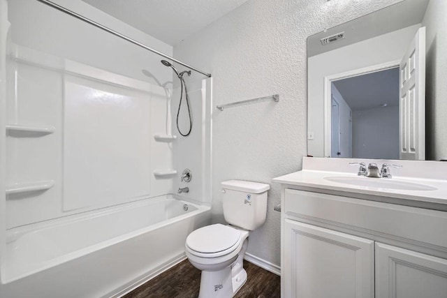 137 Green Egret Way, Leander, TX 78641 - full bath with a textured wall, wood finished floors, vanity, toilet, and shower / tub combination