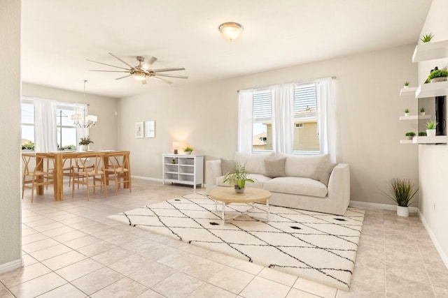 313 Pearl Way, Buda, TX 78610 - tiled living area featuring plenty of natural light, a ceiling fan, and a chandelier