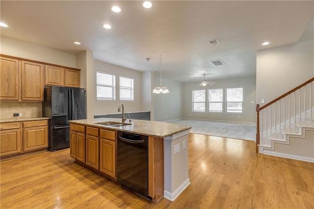 1911 Nelson Ranch Loop, Cedar Park, TX 78613 - kitchen with black appliances, a sink, light wood finished floors, a ceiling fan, and a kitchen island with sink