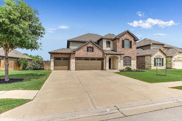 3908 Crispin Hall Ln, Pflugerville, TX 78660 - view of front of property featuring stone siding, a garage, driveway, and roof with shingles
