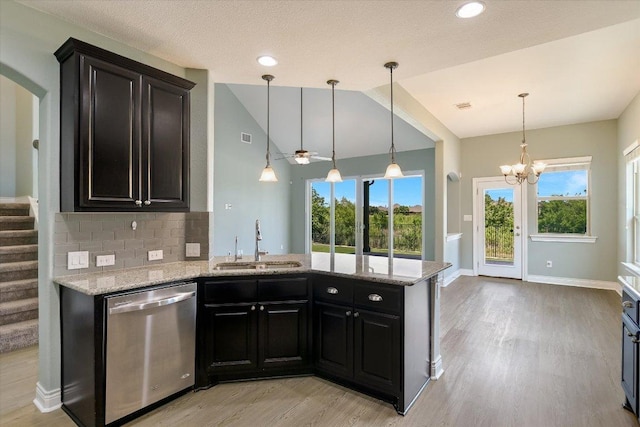3908 Crispin Hall Ln, Pflugerville, TX 78660 - kitchen with stainless steel dishwasher, a sink, light wood-style flooring, vaulted ceiling, and light stone countertops
