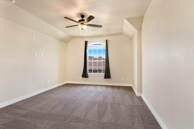 3908 Crispin Hall Ln, Pflugerville, TX 78660 - empty room with a ceiling fan, dark colored carpet, vaulted ceiling, and baseboards