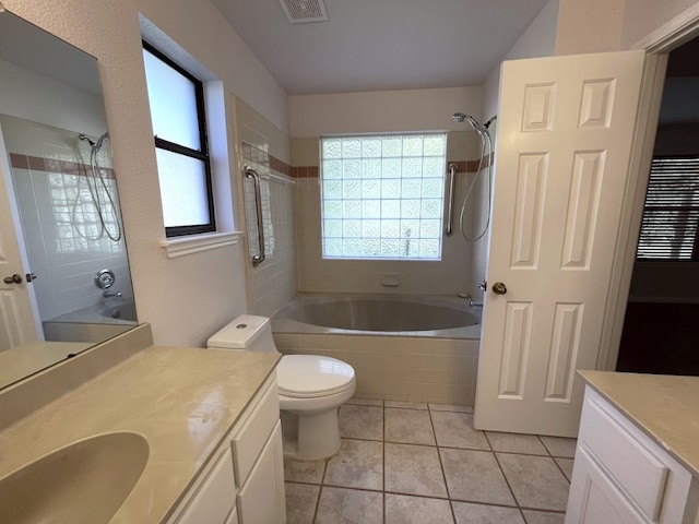 5001 Blue Bluff Rd, Austin, TX 78724 - full bathroom with tiled shower / bath, vanity, tile patterned flooring, and toilet