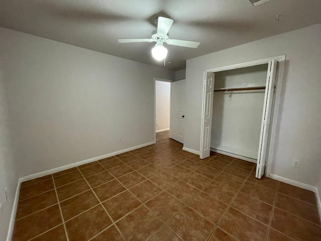 5001 Blue Bluff Rd, Austin, TX 78724 - unfurnished bedroom with baseboards, a ceiling fan, a closet, and dark tile patterned floors